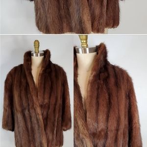 Mink coat size L with 3/4 length sleeves.